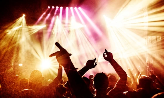 Large live music concert viewed from within the watching crowd